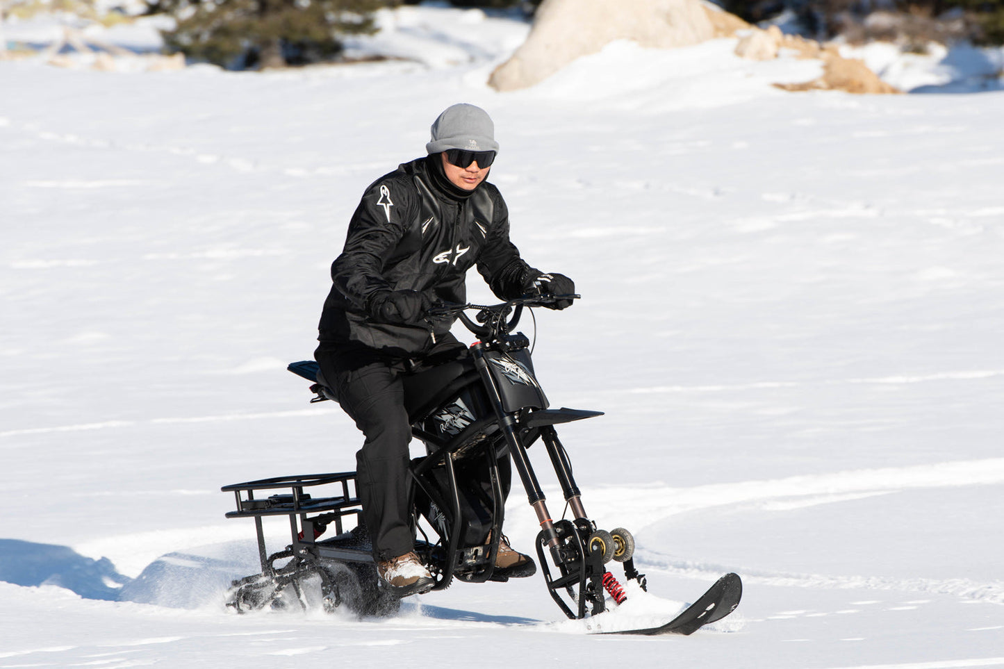Person riding a snow bike on a snowy landscape